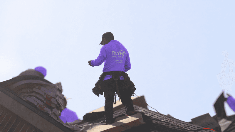 RLYNT roofing technician inspecting a shingle roof