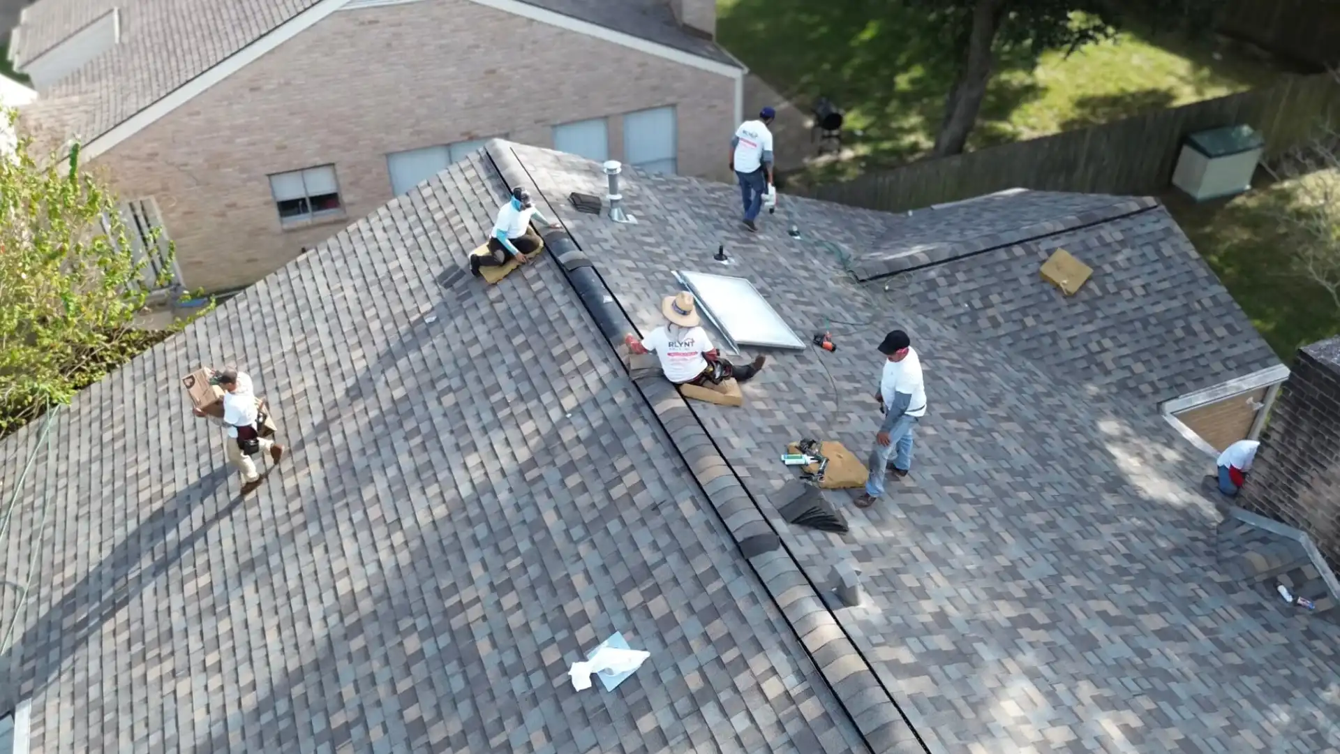 Rlynt Roofing crew inspecting a roof in Greater Houston