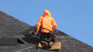 Rlynt Roofing crew member on a job in Katy, TX