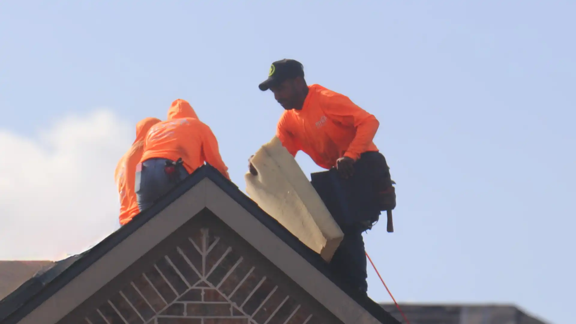 Rlynt Roofing technician installing shingles on a Houston roof