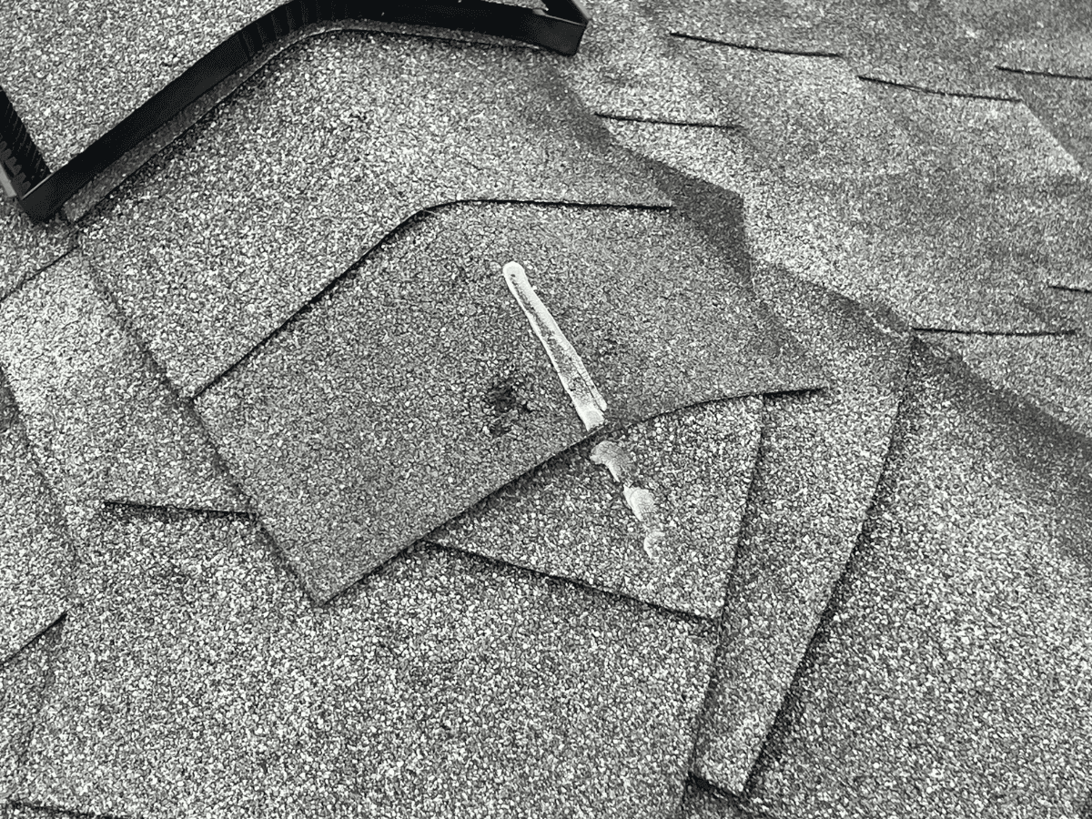 Hail damage on an asphalt shingle roof in Missouri City, Texas, documented by Rlynt Roofing